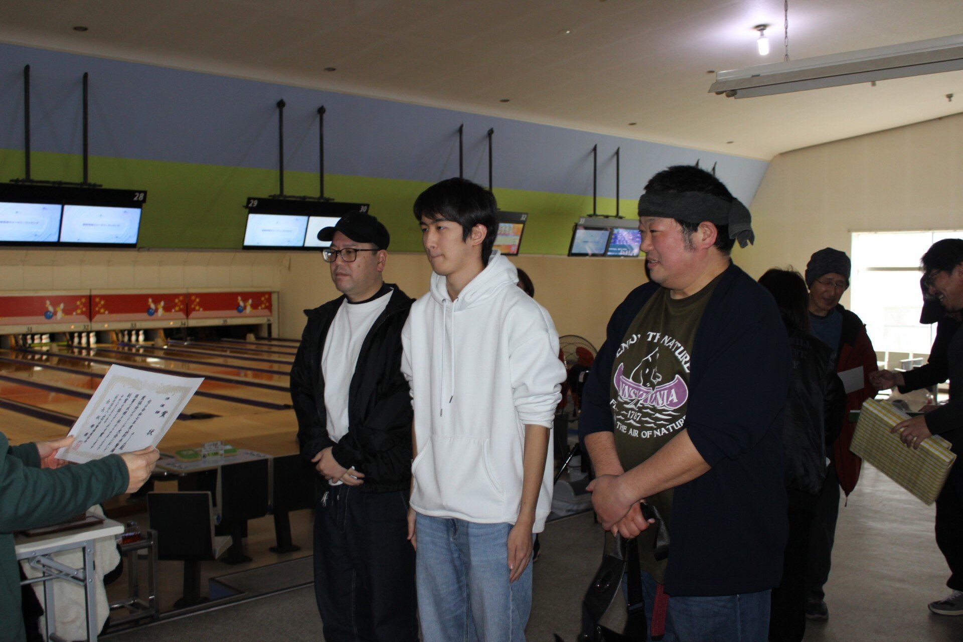 表彰されている3人